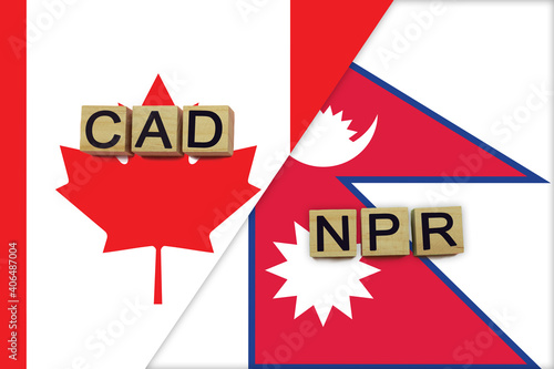 Canada and Nepal currencies codes on national flags background © andreyakaan147