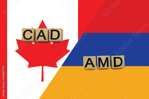 Canada and Armenia currencies codes on national flags background © andreyakaan147