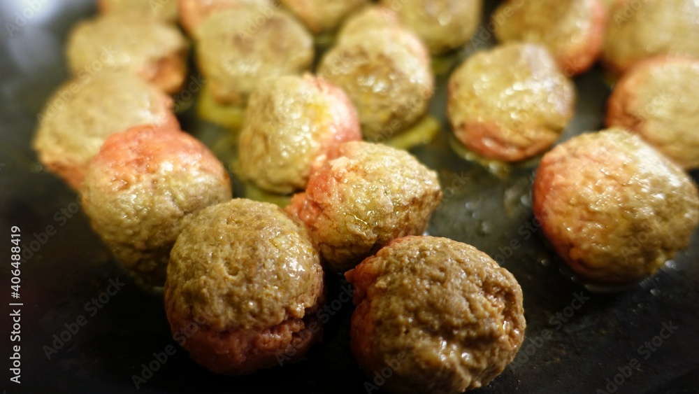 Homemade meatballs are slowly cooking in the pan Homemade meatballs are slowly cooking in the pan