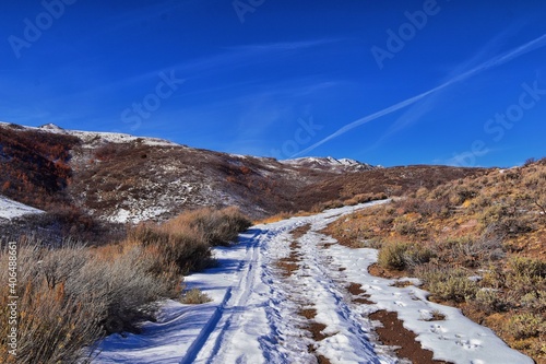 Winter snow mountain hiking trail views Yellow Fork Canyon County Park Rose Canyon by Rio Tinto Bingham Copper Mine, in winter. Salt Lake City, Utah. United States. photo