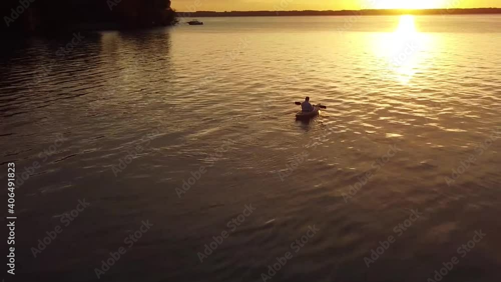 Orbital drone over kayaker at sunrise on Lake Michigan. Orbital drone over kayaker at sunrise on Lake Michigan.