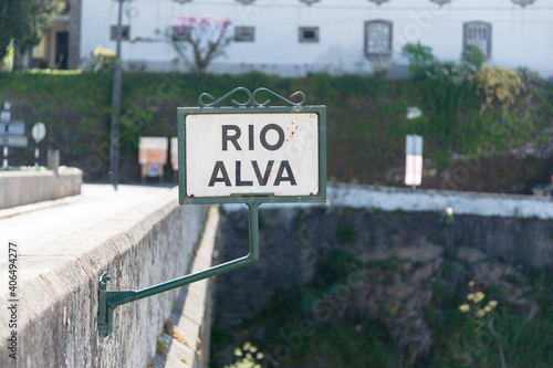 Old sign ''Rio Alva'' on a stone bridge in the historic town of Portugal called Coja photo