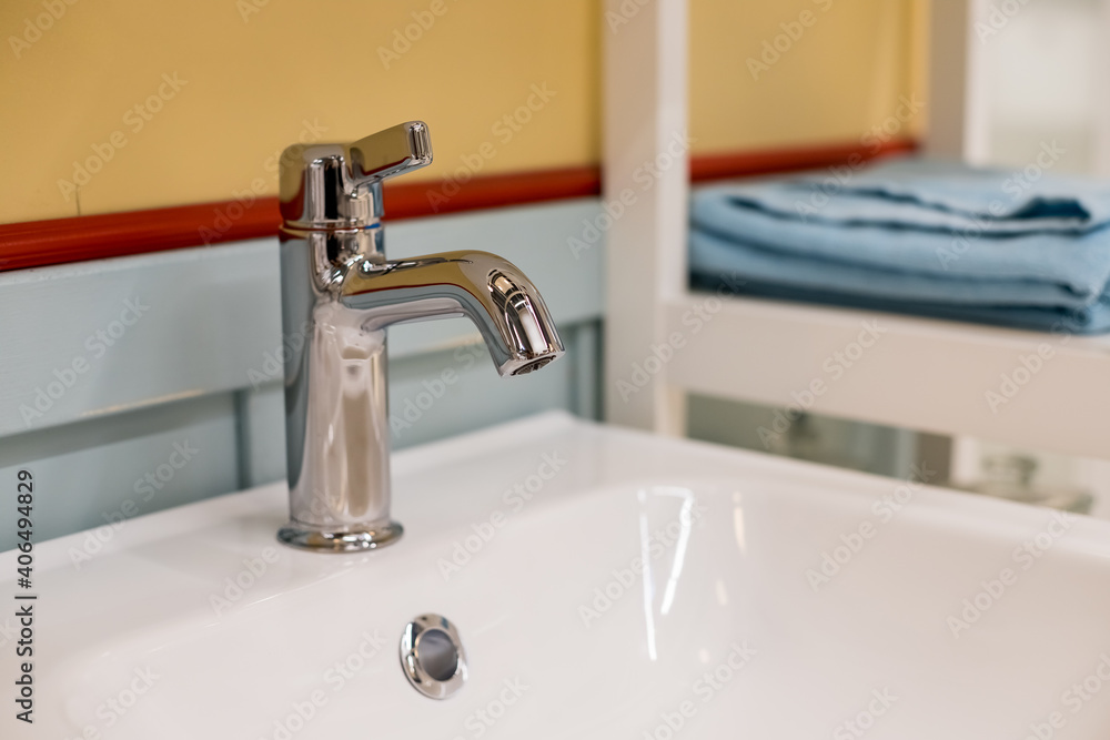 Bathroom interior with white sink and faucet.Chrome bathroom faucet. Modern design. Detail of sink in elegant bathroom.Water tap Bathroom interior with white sink and faucet.Chrome bathroom faucet. Modern design. Detail of sink in elegant bathroom.Water tap