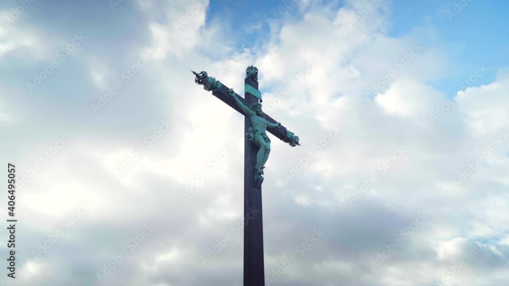 Looking up Jesus cross statue on a cloudy and blue sky, powerful religion and faith symbol Looking up Jesus cross statue on a cloudy and blue sky, powerful religion and faith symbol