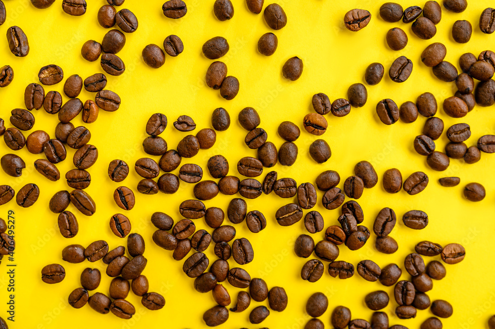 Coffee beans closeup isolated on yellow background Coffee beans closeup isolated on yellow background