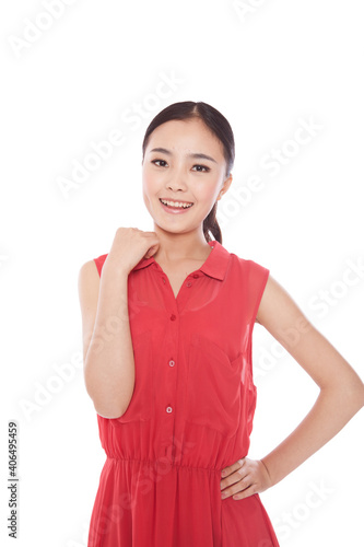 A Young woman standing in red dress © eastfenceimage