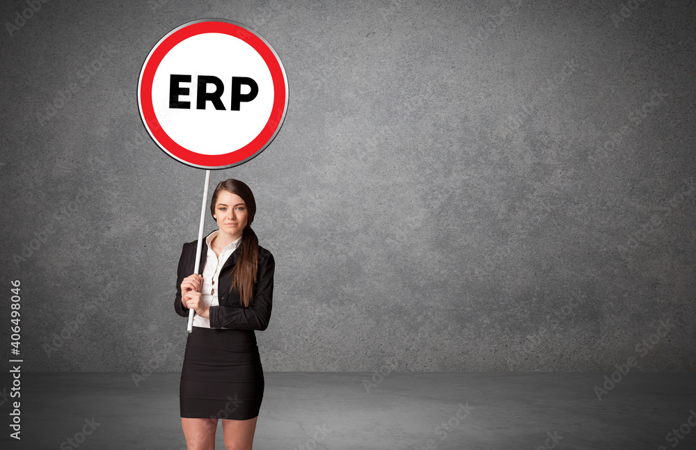 Young business person holdig traffic sign with ERP abbreviation, technology solution concept Young business person holdig traffic sign with ERP abbreviation, technology solution concept