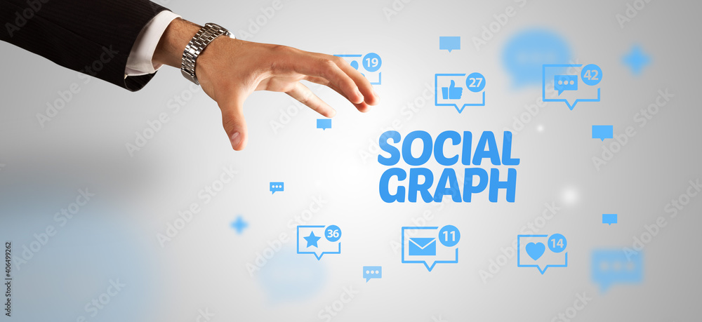 Close-Up of cropped hand pointing at SOCIAL GRAPH inscription, social networking concept Close-Up of cropped hand pointing at SOCIAL GRAPH inscription, social networking concept