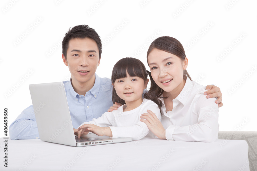 Portrait of daughter playing laptop with parents Portrait of daughter playing laptop with parents