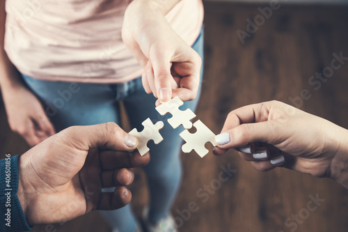 A group of business people assembling puzzle