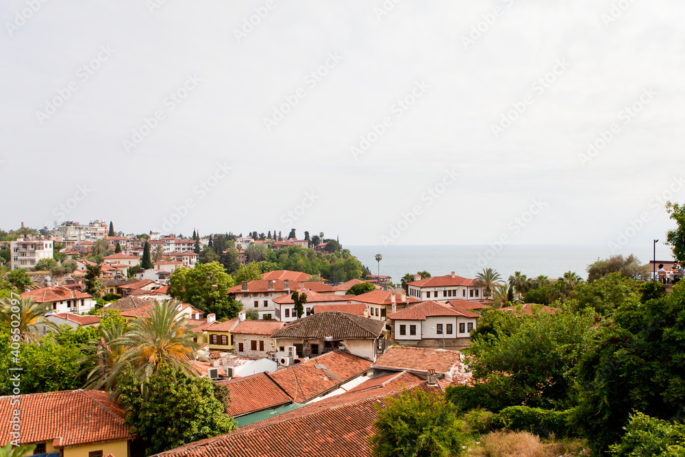 Sea view through the red roofs of the city