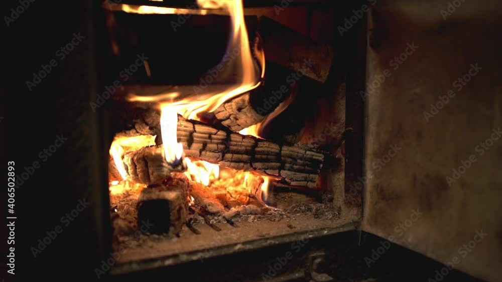 Tranquil view of wood burning in cast iron stove in kitchen before cooking Tranquil view of wood burning in cast iron stove in kitchen before cooking
