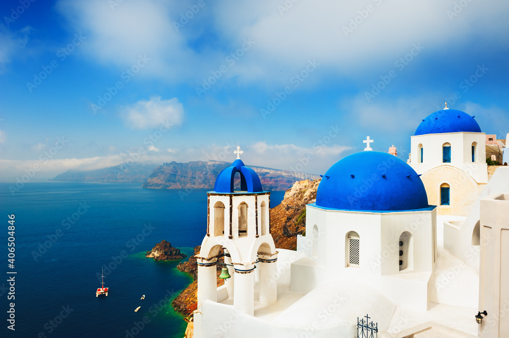 Traditional greek church with blue domes in Oia, Santorini island, Greece. Famous travel destination