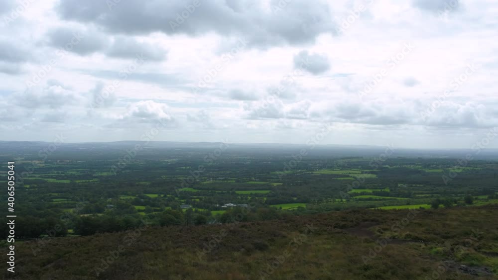 Amazing view from a hill into the green valley with multiple trees on a cloudy and foggy day in Ireland. Drone dolly shot Amazing view from a hill into the green valley with multiple trees on a cloudy and foggy day in Ireland. Drone dolly shot