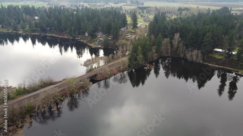 Aerial view of Patterson lake in Olympia, Washington divided by train tracks on a small bridge photo