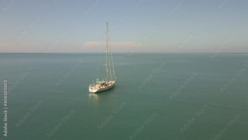 Aerial orbit view of sailing Yacht ocean with Islands and turquoise ocean Aerial orbit view of sailing Yacht ocean with Islands and turquoise ocean