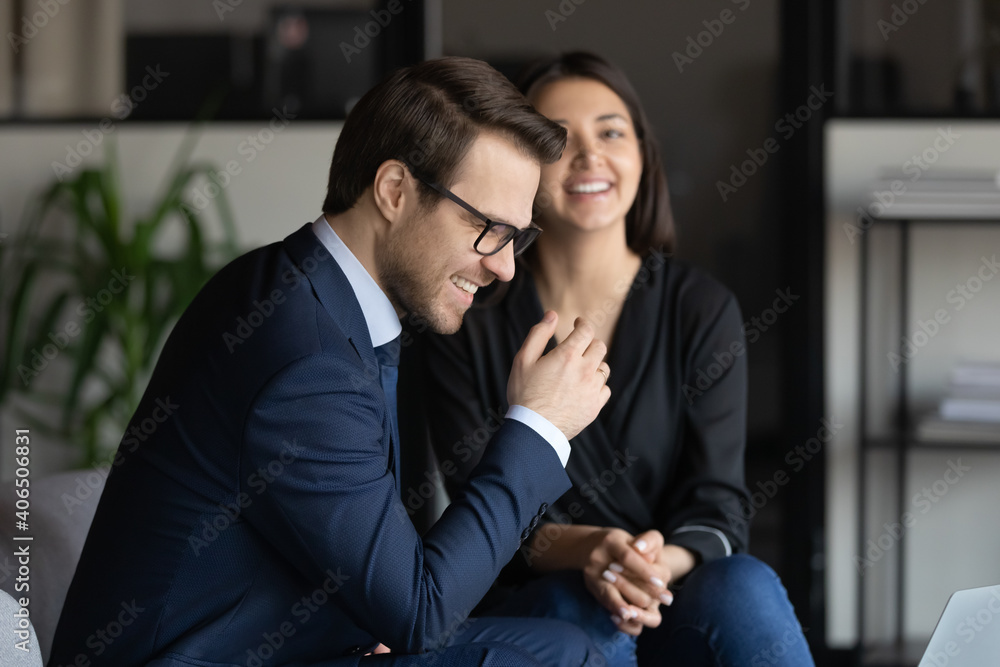 Close up happy diverse colleagues chatting, excited businessman wearing glasses and Indian businesswoman laughing at joke, discussing funny news, employees having fun during break in modern office Close up happy diverse colleagues chatting, excited businessman wearing glasses and Indian businesswoman laughing at joke, discussing funny news, employees having fun during break in modern office
