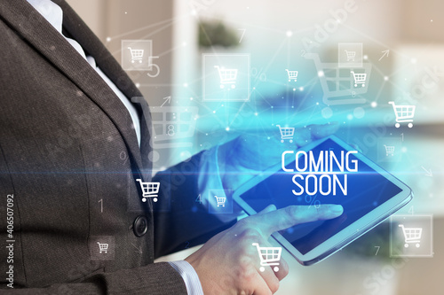 Young person makes a purchase through online shopping application with COMING SOON inscription
