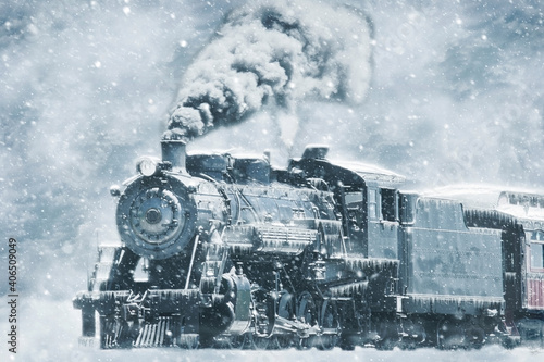 A Restored Steam Engine Steamed Up in a Snow Storm With Icicles on it