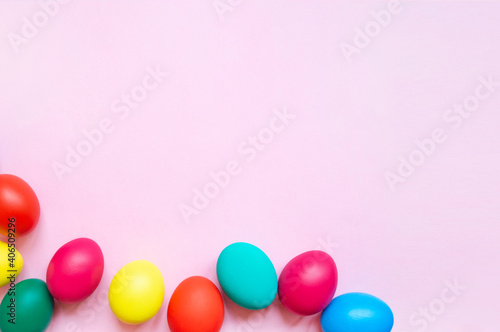 colorful easter eggs on pink background with copy space. Easter background