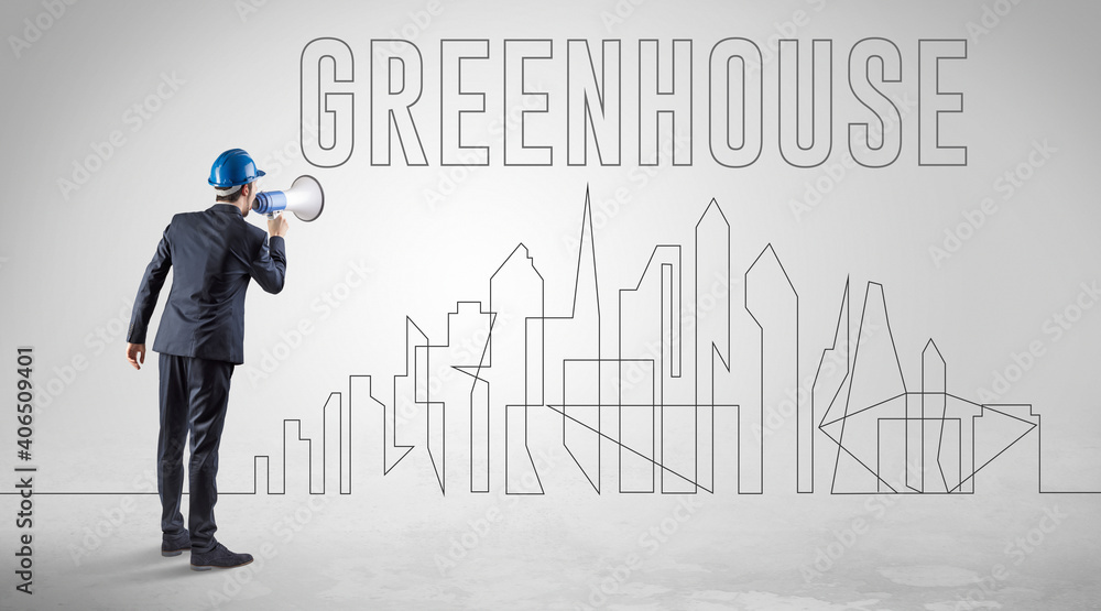 Businessman in hard hat holding blueprint with GREENHOUSE inscription, engineering and architecture concept Businessman in hard hat holding blueprint with GREENHOUSE inscription, engineering and architecture concept