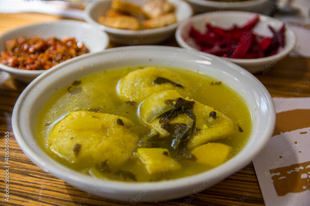 Traditional hot yellow Kubbe soup, a famous middle eastern dumplings soup dish, served in a bowl. Jerusalem, Israel. Traditional hot yellow Kubbe soup, a famous middle eastern dumplings soup dish, served in a bowl. Jerusalem, Israel.