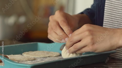 Folding and rolling the nubbin of a Tradicional Georgia dumpling, Khinkali - Side view eye level close up photo