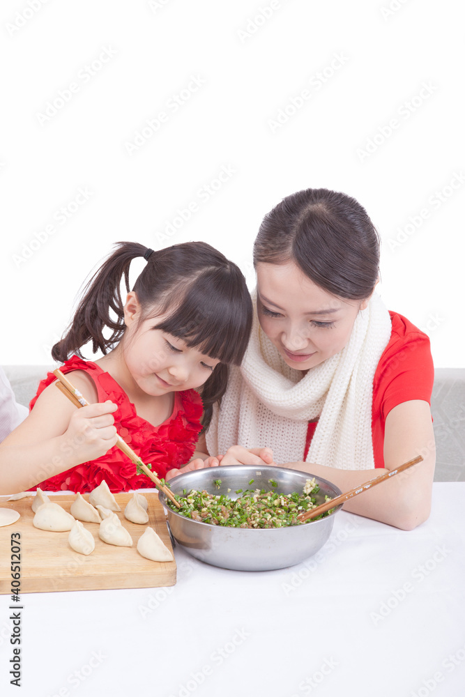 Portrait of mother and daughter making dumplings Portrait of mother and daughter making dumplings