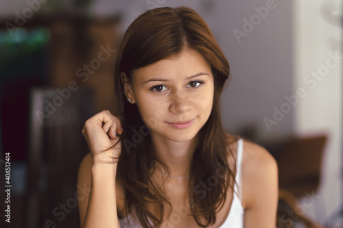 Young girl in cafe looking right to the camera