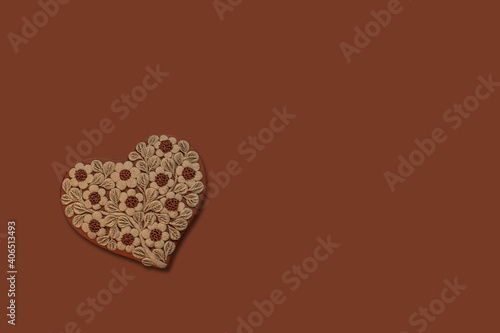 Fototapeta Top view of a heart shape with flowers sewed on it isolated on a brown backgroun