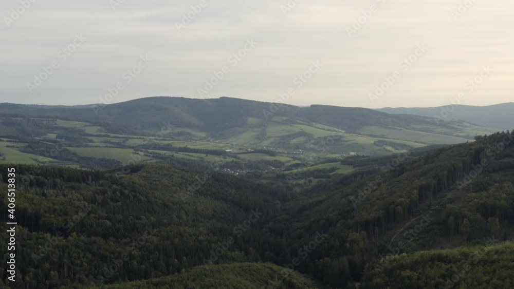 Slow forward aerial of green forested hills in rural Central Europe Slow forward aerial of green forested hills in rural Central Europe