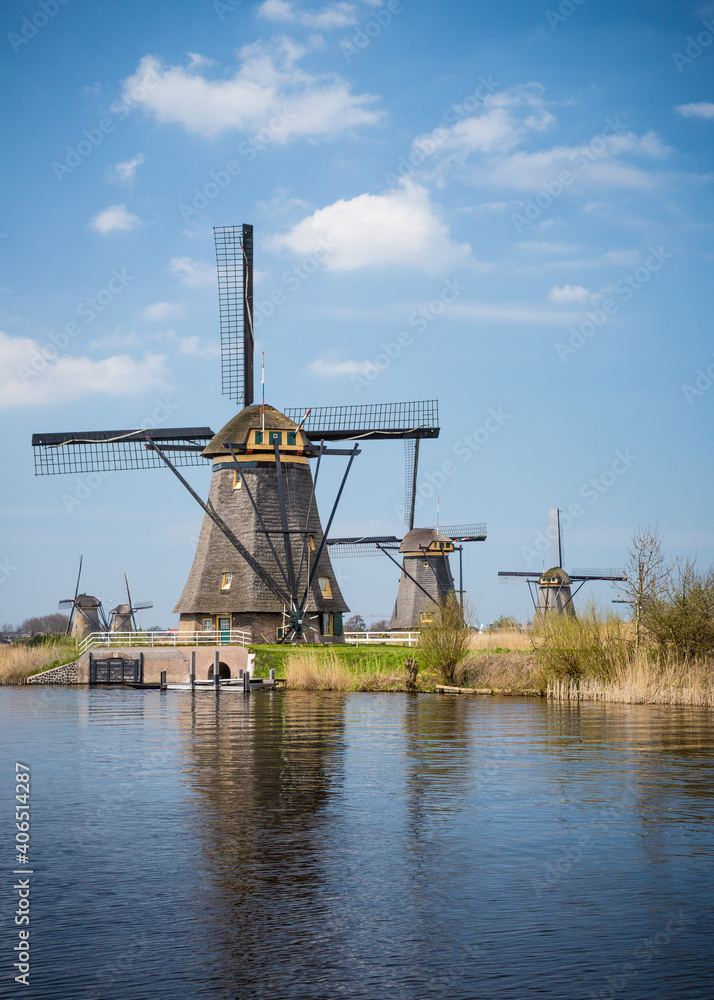 Five windmills in Holland field by water in Kinderdijk