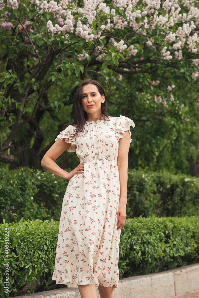 Young elegant girl posing at city street. Pretty beautiful business woman in elegant dress against city background. Young elegant girl posing at city street. Pretty beautiful business woman in elegant dress against city background.
