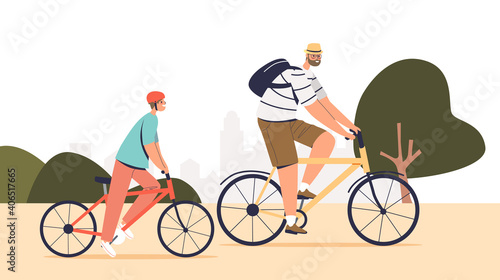 Father and son riding bicycle outdoors in park. Cute boy with dad cycling together
