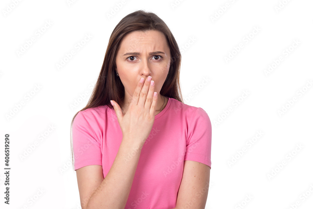Secret. Surprised woman covering her face with her hands, isolated on white background. Female brunette in a pink sweater. Place for text. Secret. Surprised woman covering her face with her hands, isolated on white background. Female brunette in a pink sweater. Place for text.