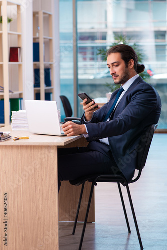 Young male employee working in the office