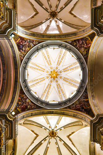 Low angle shot of the classic ceiling dome inside a Cathedral in Villareal, Valencia in Spain photo