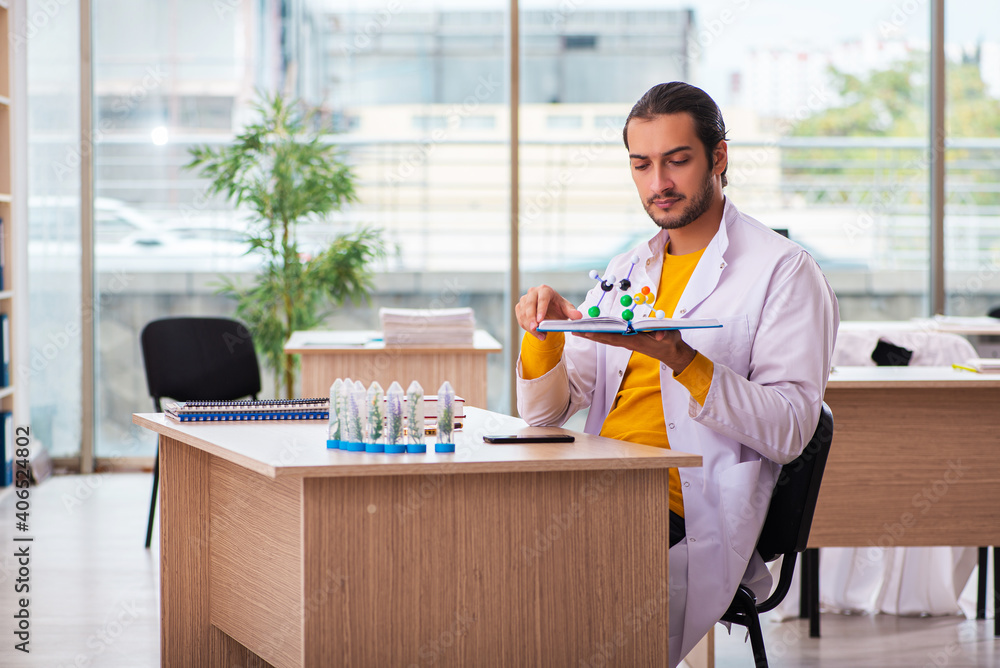 Young male chemist in drug synthesis concept Young male chemist in drug synthesis concept