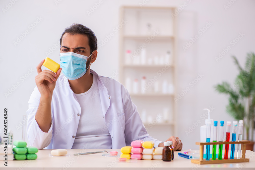 Young male chemist testing soap in the lab Young male chemist testing soap in the lab