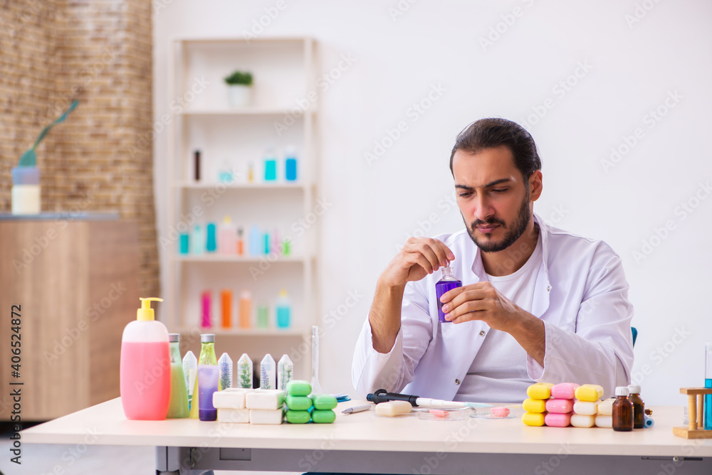 Young male chemist testing soap in the lab Young male chemist testing soap in the lab