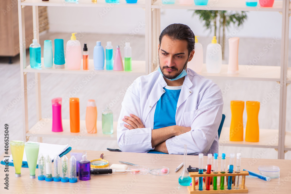 Young male chemist testing soap in the lab Young male chemist testing soap in the lab
