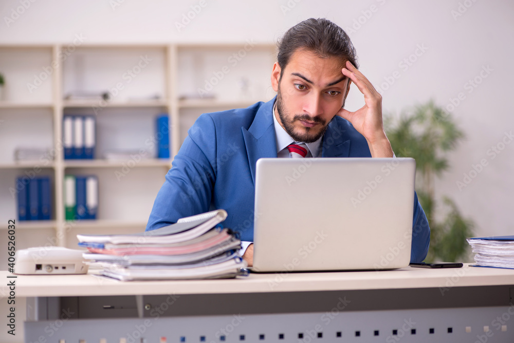 Young male employee working in the office Young male employee working in the office