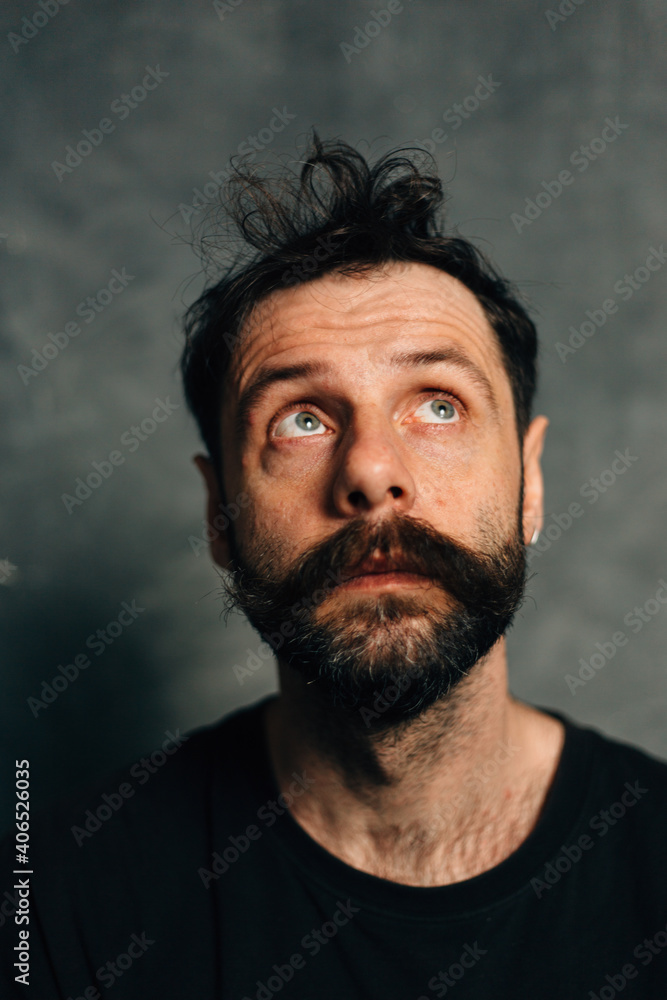 Portrait of a courageous guy with a beard and mustache on a canvas background Portrait of a courageous guy with a beard and mustache on a canvas background
