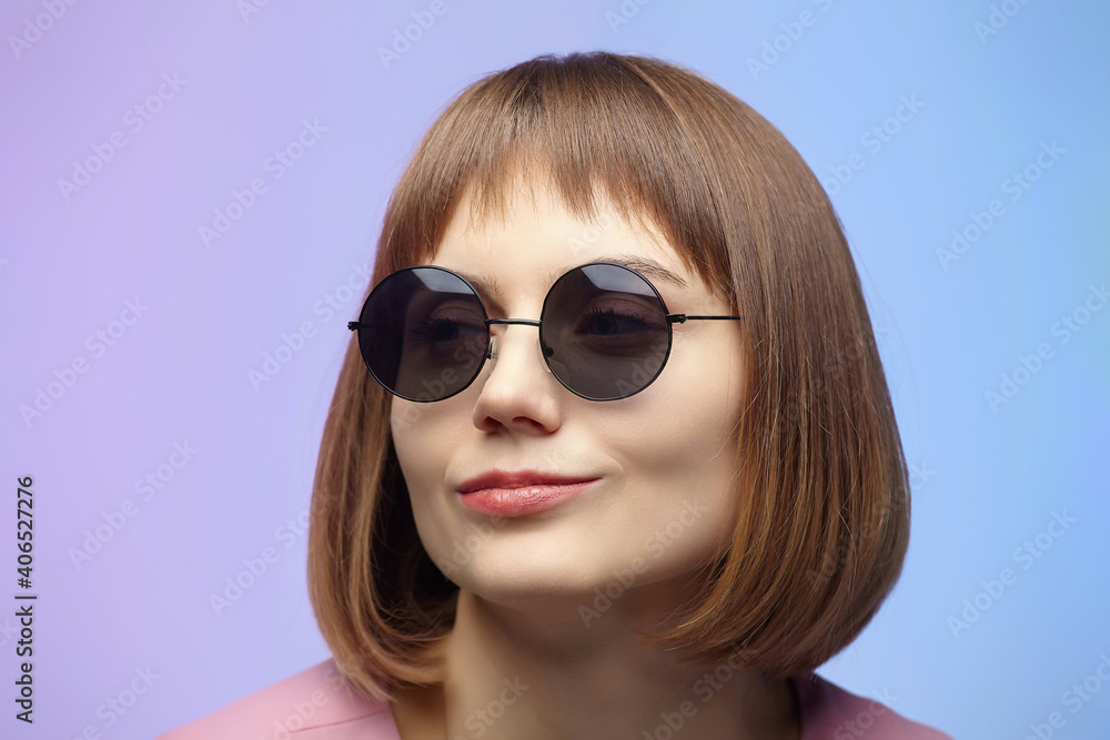 stylish girl in sunglasses. photo shoot in the studio on a pink background stylish girl in sunglasses. photo shoot in the studio on a pink background