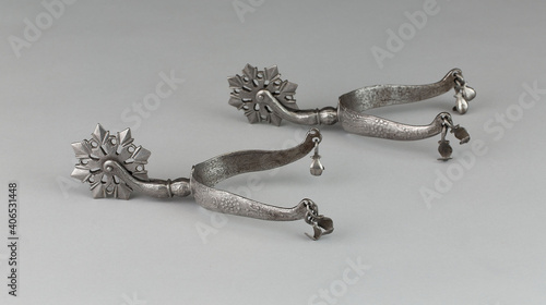 Pair of vintage rowel spurs on a white background photo