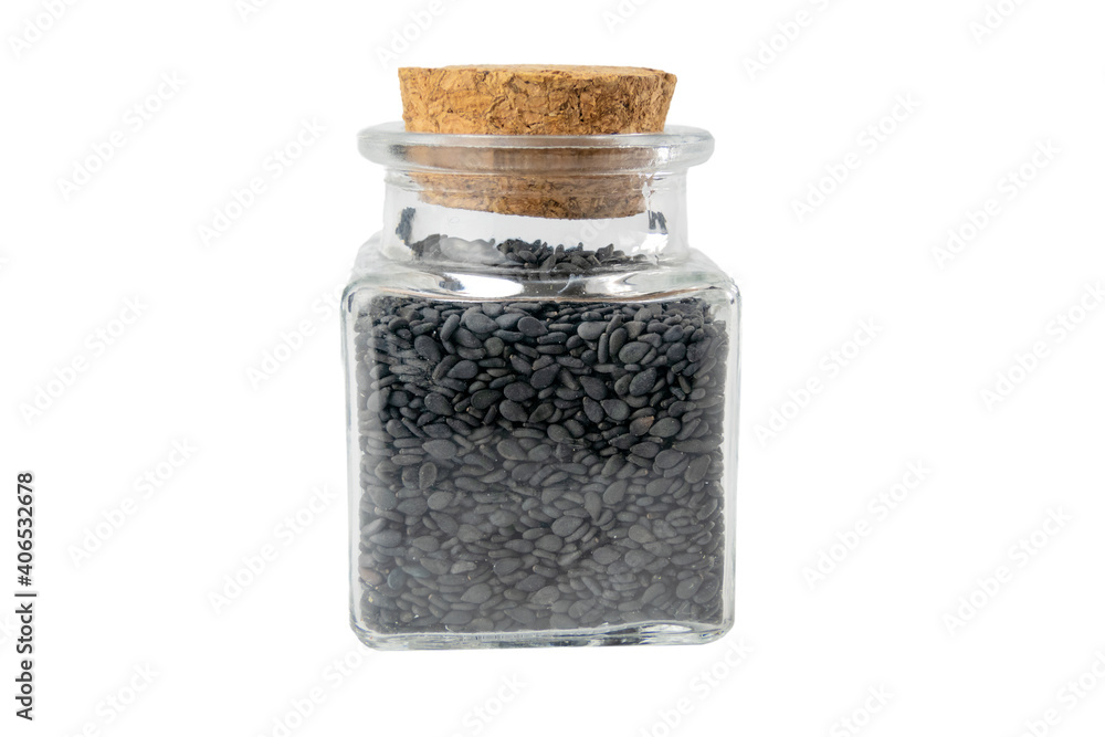 Black Sesame seeds in a glass jar isolated on white background. Spices and food ingredients. Black Sesame seeds in a glass jar isolated on white background. Spices and food ingredients.