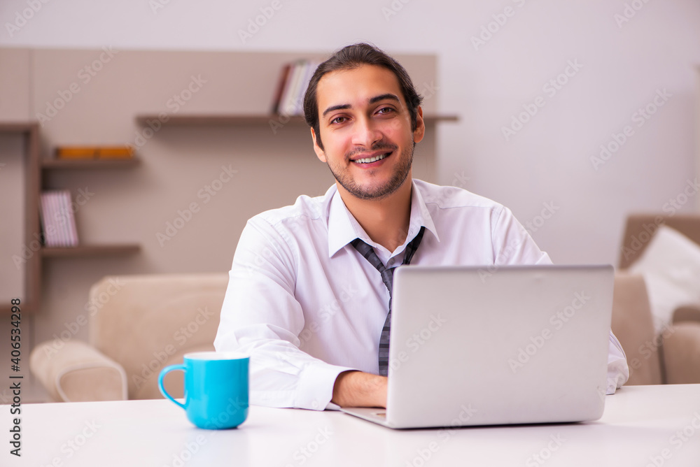 Young male employee working from home during pandemic Young male employee working from home during pandemic