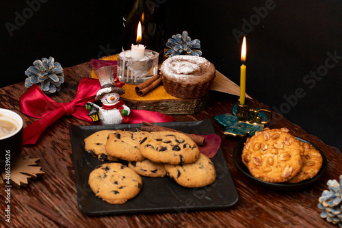 Festive table with cookies, candles and a snowman photo