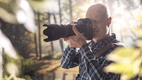 Wildlife photographer shooting in a forest © StockPhotoPro