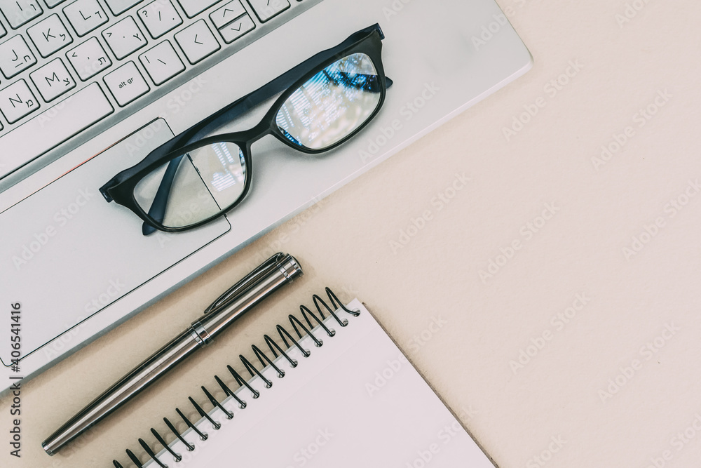 Business composition with laptop, glasses, fountain pen, notebook on a work desk. Business composition with laptop, glasses, fountain pen, notebook on a work desk.
